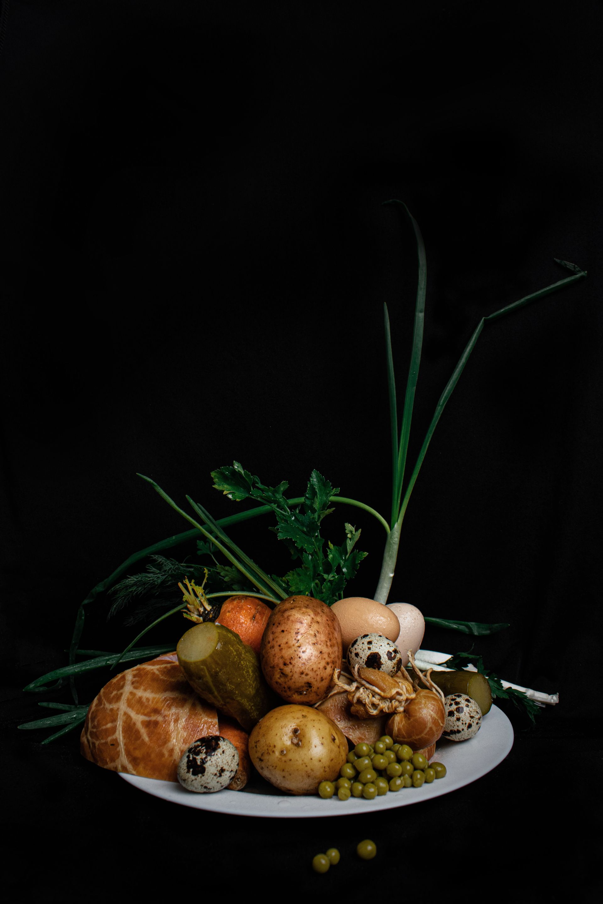Whole foods arranged on a plate against a black background